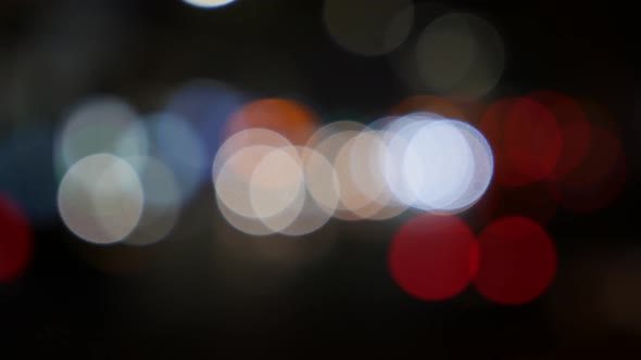 Beautiful Glittering Bokeh in Dark Blurry Background at Night