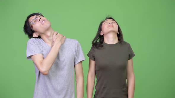 Young Asian Couple Having Neck Pain Together