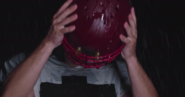 Portrait of the Determined Professional American Football Player in Dark Night Holding the Ball