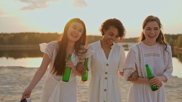 Group of Female Friends Having Fun on a Lake Beach at the Party