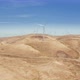 Aerial Close Up Footage of a Spinning Windmill at a Windfarm Over the Fields - VideoHive Item for Sale