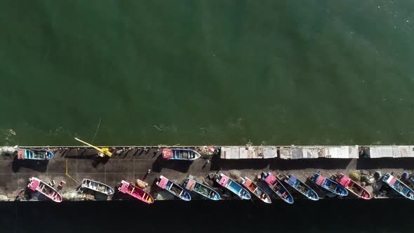 Fishermen's Boats On The Port Of Playa Maguillines In Constitucion, Maule, Chile. Aerial Tracking Sh alt
