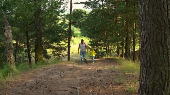 Father and Child Walk in Forest