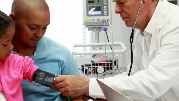 Male doctor checking patient blood pressure alt