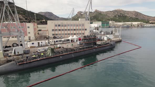 Aerial orbit Spanish submarine docked to maintenance works, Cartagena navy harbor.