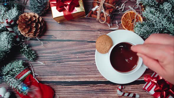 Cookies and a mug of hot cocoa on a wooden table in the atmosphere of Christmas