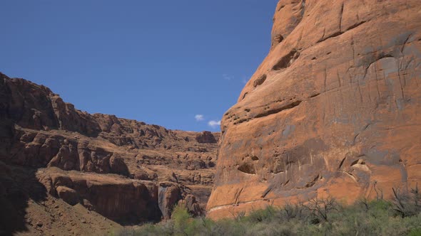 Arid cliffs and a blue sky alt