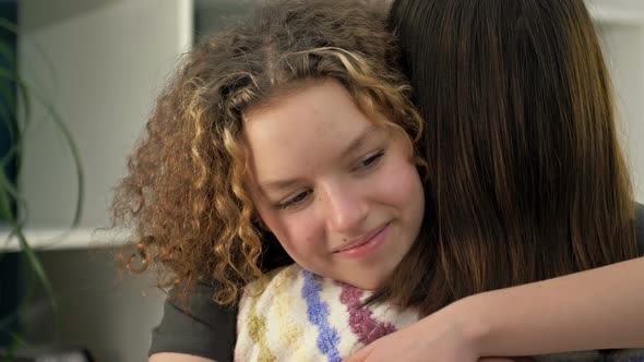 Teenage Girl Happily Hugs Her Mom or Girlfriend