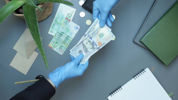 Businessman giving cash money to partner alt