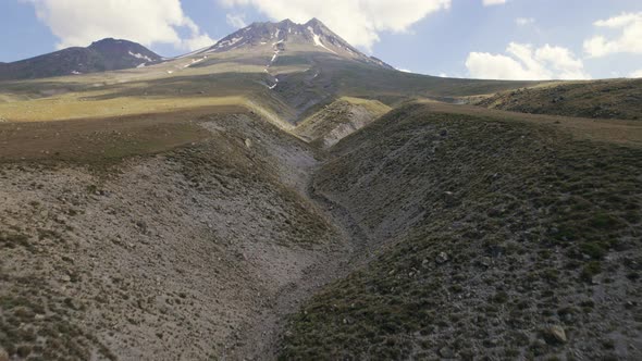 Drone Flies to Mountain Over the Surface