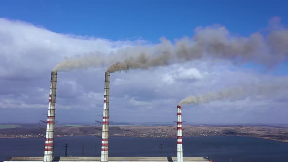 Aerial View of Old Thermoelectric Plant with Big Chimneys in a Rural Landscape Near the Reservoir alt