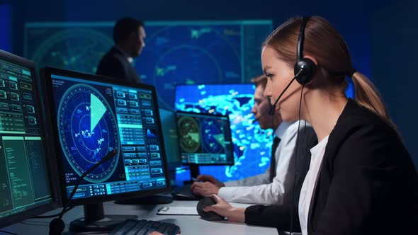 Workplace of the air traffic controllers in the control tower. Team of professional officers. alt