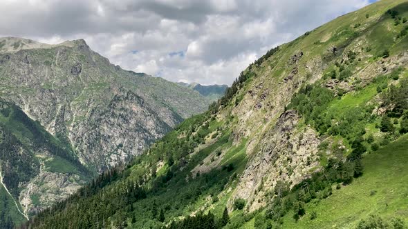 Peaks of Magnificent Rocks Located Against Bright Cloudy Sky on Sunny Day in Nature alt