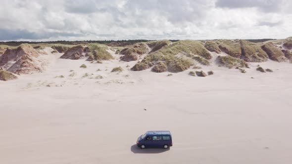 Aerial view of van driving on the beach of borsmose in Denmark alt