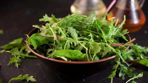 Mix salad greens. Arugula, lettuce, spinach in black bowl Video 4k