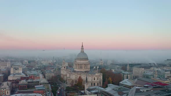 Circling establishing drone shot of St Pauls Cathedral London at sunrise alt