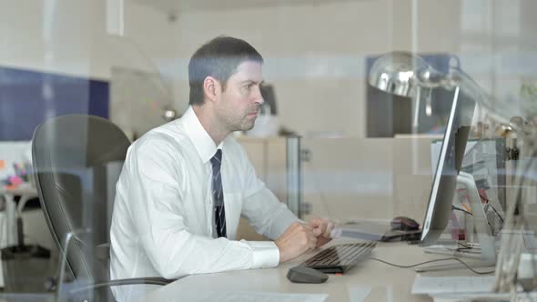 Disappointed Middle Aged Businessman Working on Office Computer and Get Shocked alt