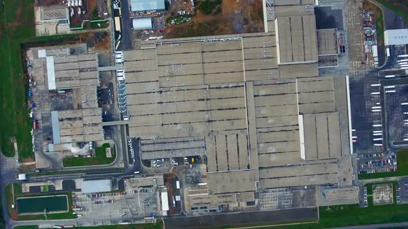 Manufacture on field. Industrial zone with car parking.  alt