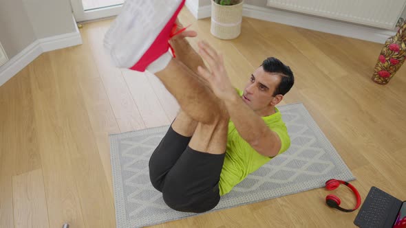 High Angle View of Muscular Middle Eastern Sportsman Reaching Tiptoes with Hands Lying on Exercise alt