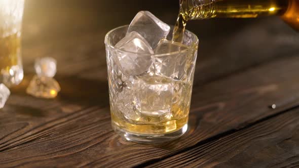 Pouring Whiskey in a Glass with Ice Cubes