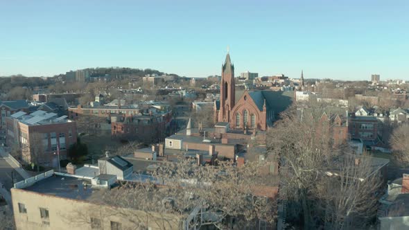 Aerial Drone Shot Ascending Past a Street and  Church Steeple in Suburban Boston alt