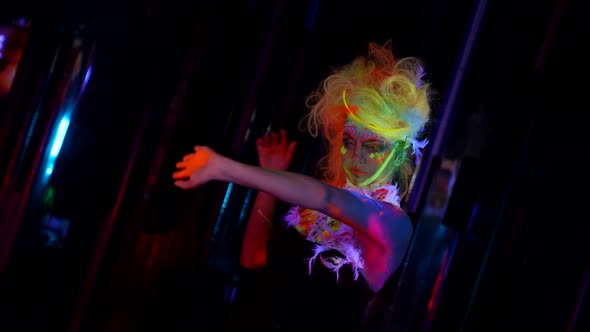 Mysterious Woman in Uv Lights in Darkness Glowing Fluorescent Makeup and Hair alt