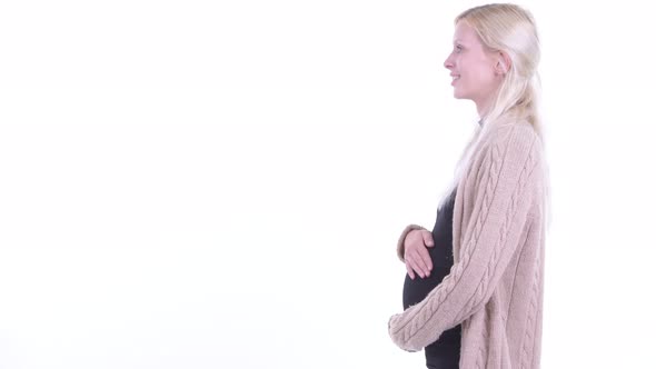 Profile View of Happy Young Blonde Pregnant Woman Smiling alt