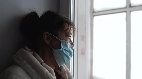 Old Illness Woman Grandmother Mother in Medical Mask Stay at Home Looks Sadness Thoughtful Out of