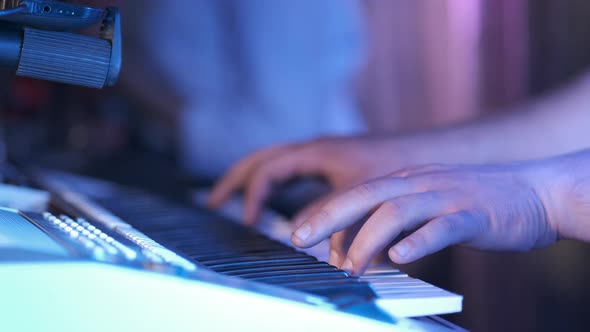 Musician playing on the keyboard synthesizer piano keys. Musician plays a musical instrument 
