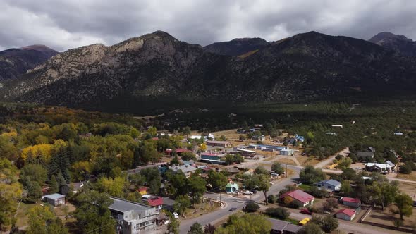 Colorado mountain town during the fall with the Rockies in the background, Aerial alt