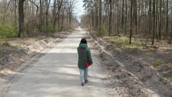 Girl Walking in the Spring Forest.