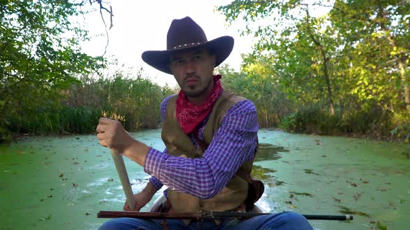 Cowboy in a Canoe Floats on the River alt