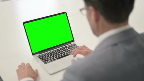 Man using Laptop with Green Chroma Screen alt