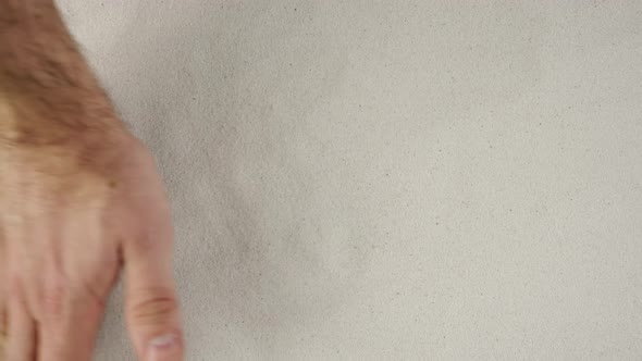 Man's Hand is Clearing the Sand Demonstrating Advertising Area Workspace Mock Up alt