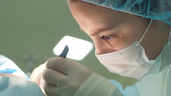 Surgeon Woman Performs Surgery on Patient
