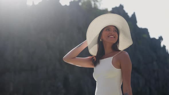 Woman In Hat Looking Up Under Glowing Sunlight alt