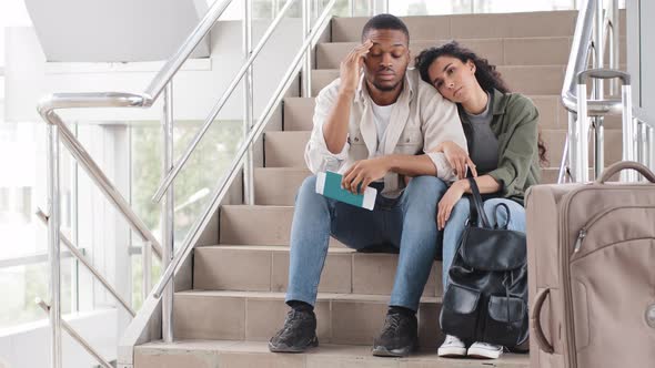 Multiracial Couple Multiethnic Newlyweds Afro American Man and Hispanic Woman Sitting in Airport alt