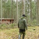 A Hunter Walks to Hunting Hut Through the Autumn Forest - VideoHive Item for Sale
