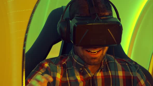Excited Young Man Enjoying Virtual Reality Attraction alt