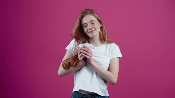 The Young Redhead with the White Helmet of an Engineer Smiles Optimistically and Looks Ahead alt