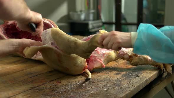 Butcher Cutting Pork Carcass at Slaughterhouse alt