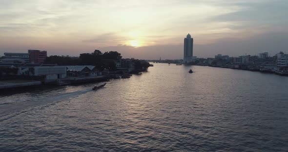 Aerial view of a longtail boat on the Chao Phraya river in Bangkok Thailand. alt