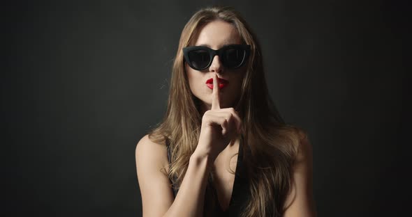 Woman on Black Background Whispering