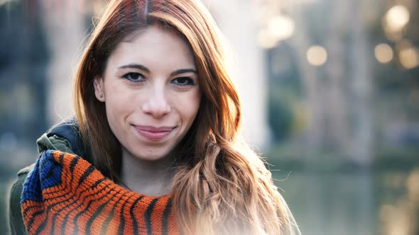 Confident attractive young red hair woman turning and looking at camera-outdoor alt