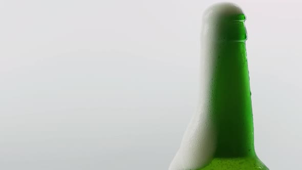 Light Beer In A Bottle. Open A Beer Bottle With A Bottle Opener, Green Beer Bottle alt