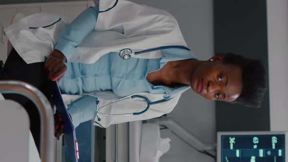 Vertical Video Front View of Afro American Medical Specialist and Sick Man Having Online Videocall alt