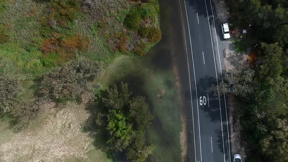 Aerial footage of police directing traffic away from a flooded roadway after a recent down pour on t alt