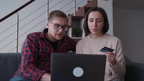 Man and Woman Using Laptop and Making Online Shopping with Credi