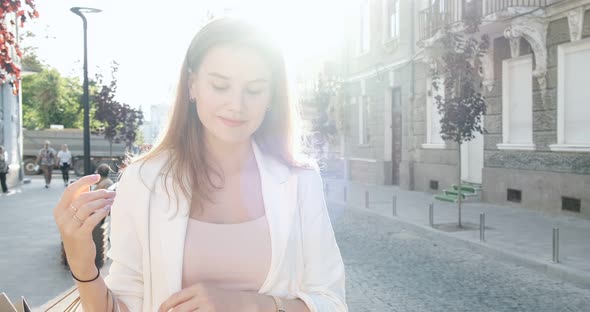 Happy, Smiling, Beautiful, Young Woman Walks Through the City on Shopping with Purchases in the alt