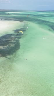 Vertical Video Kitesurfing Near the Shore of Zanzibar Tanzania alt